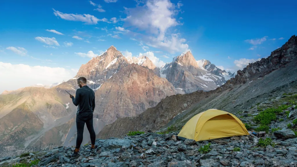 A hiker off-grid using a satellite phone